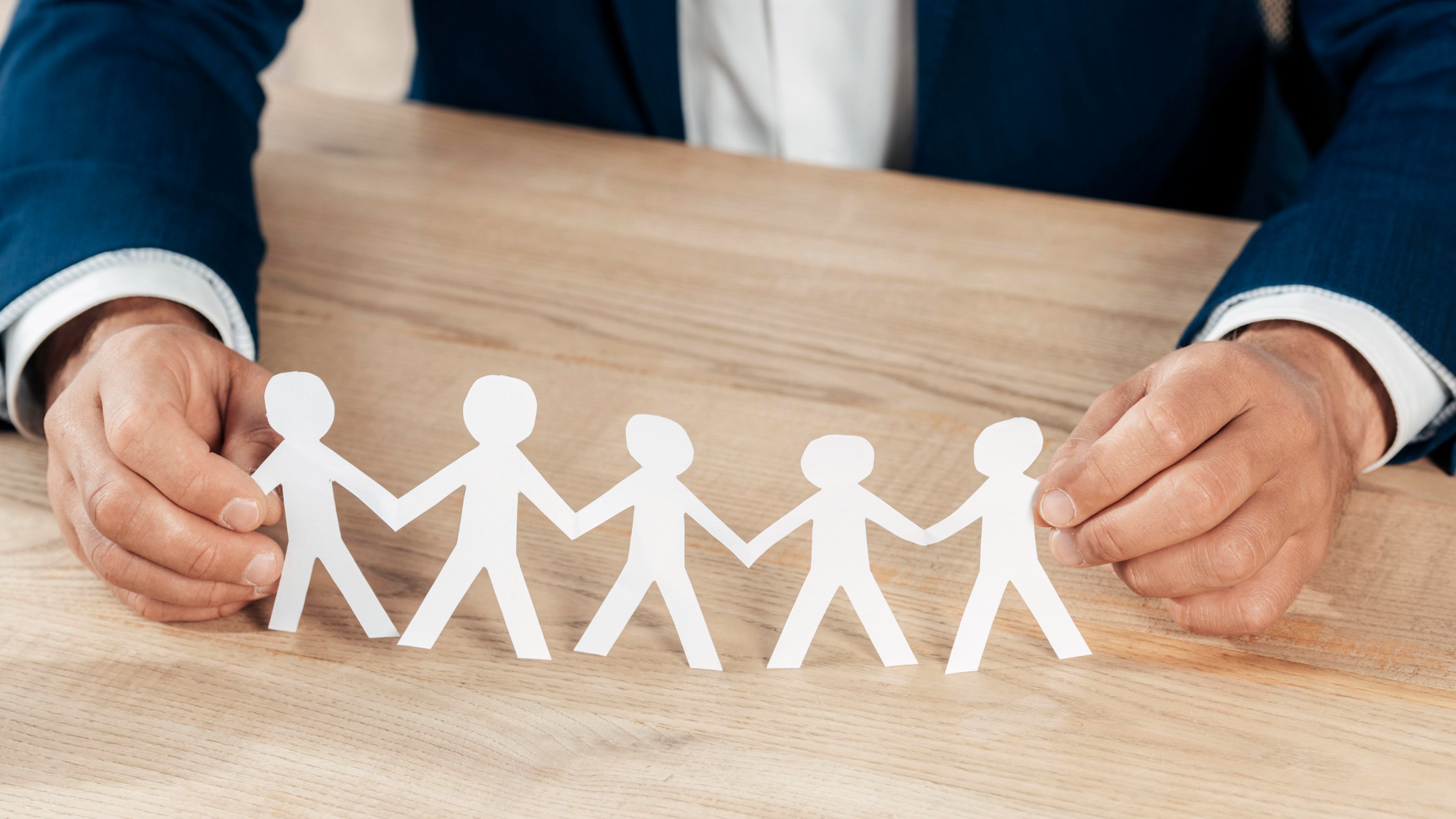 close-up-hands-holding-paper-people